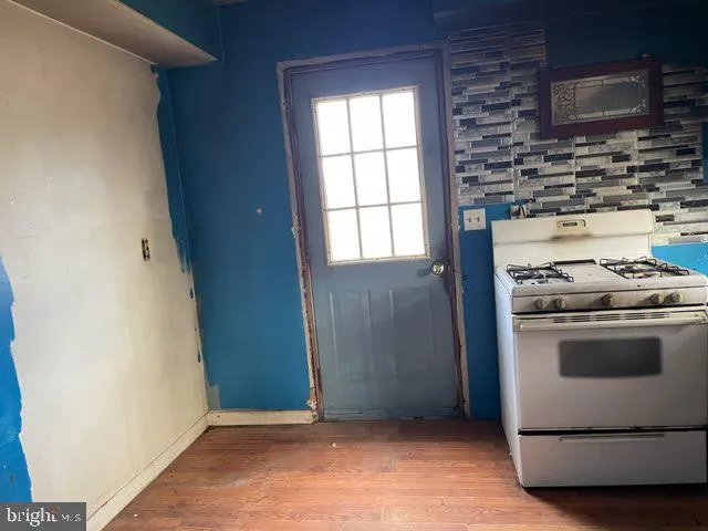 an empty room with windows and wardrobe