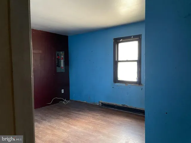 a view of a room with wooden floor and windows