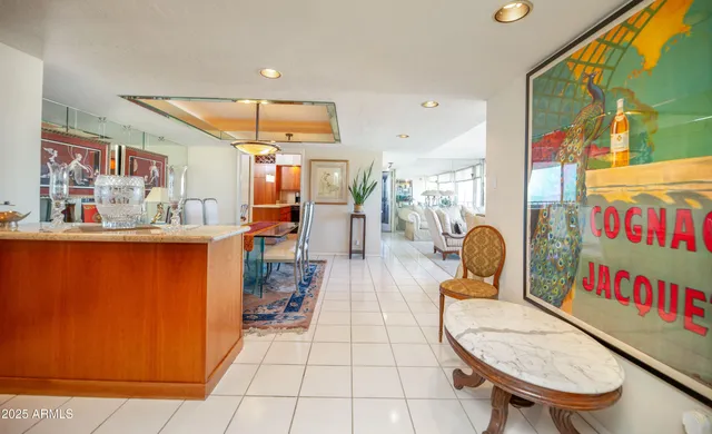 a dining room with furniture a chandelier and wooden floor