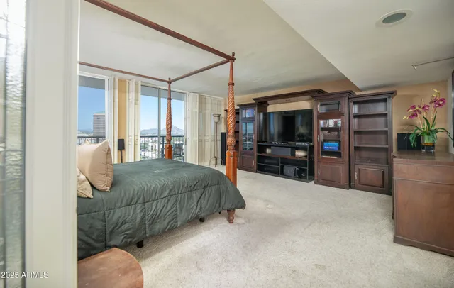 a bedroom with a bed and a mirror