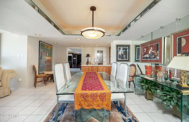 a kitchen with a table chairs and cabinets