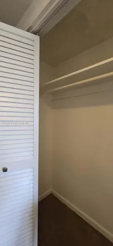 a bathroom with a sink a toilet a mirror and shower