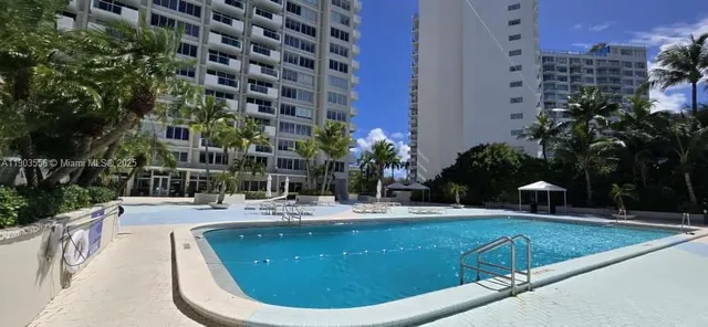 a view of swimming pool with outdoor seating and plants
