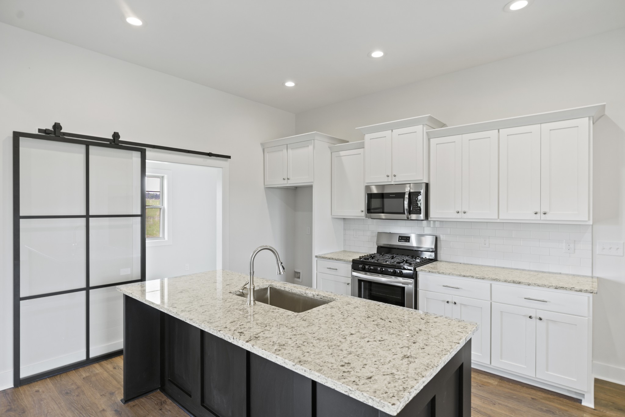 3368 Calista Road White House, TN 37188 - Photo 11 of 37 a kitchen with granite countertop a sink stove and refrigerator