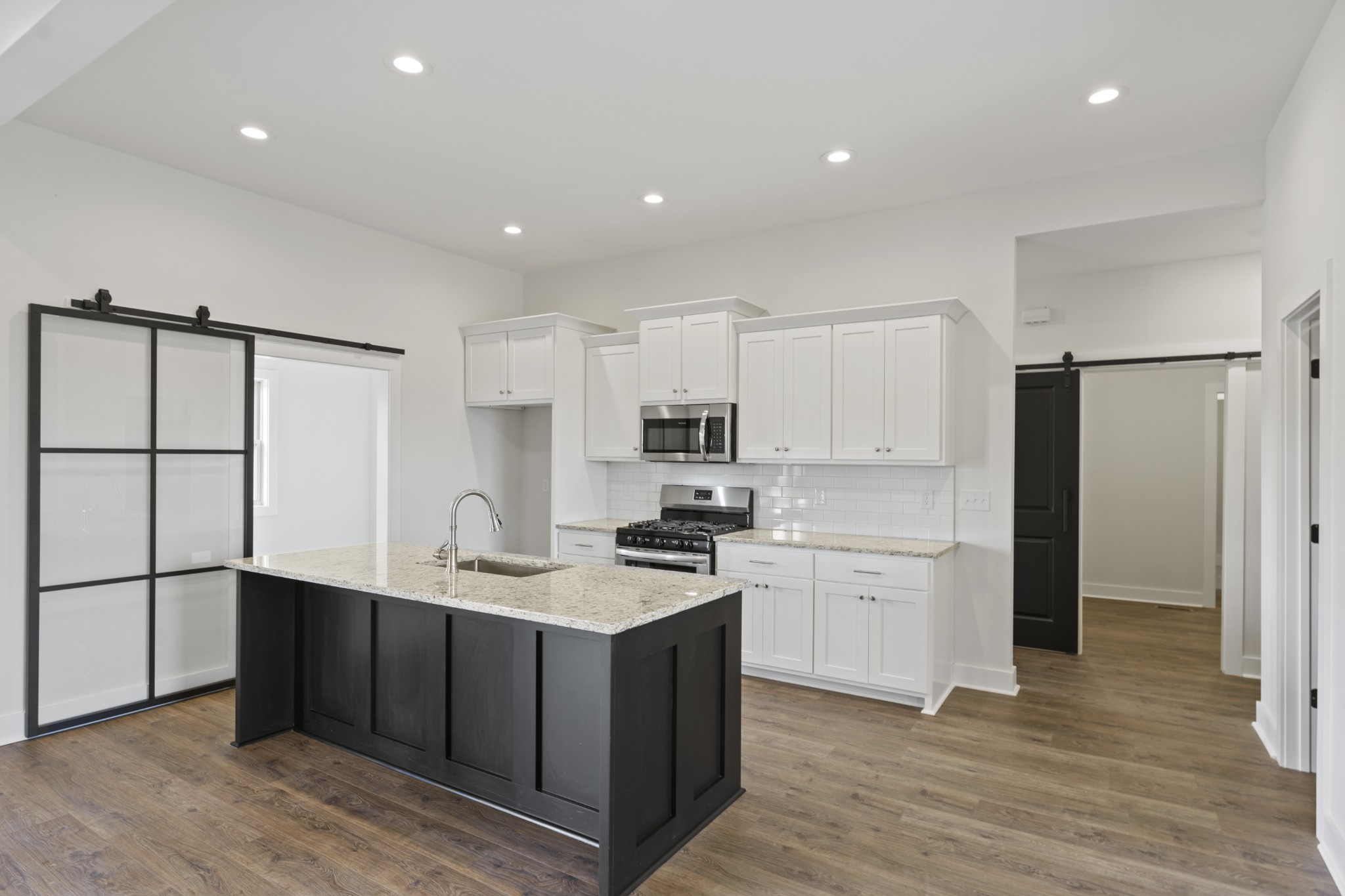 3368 Calista Road White House, TN 37188 - Photo 14 of 37 a kitchen with a sink a refrigerator and white cabinets