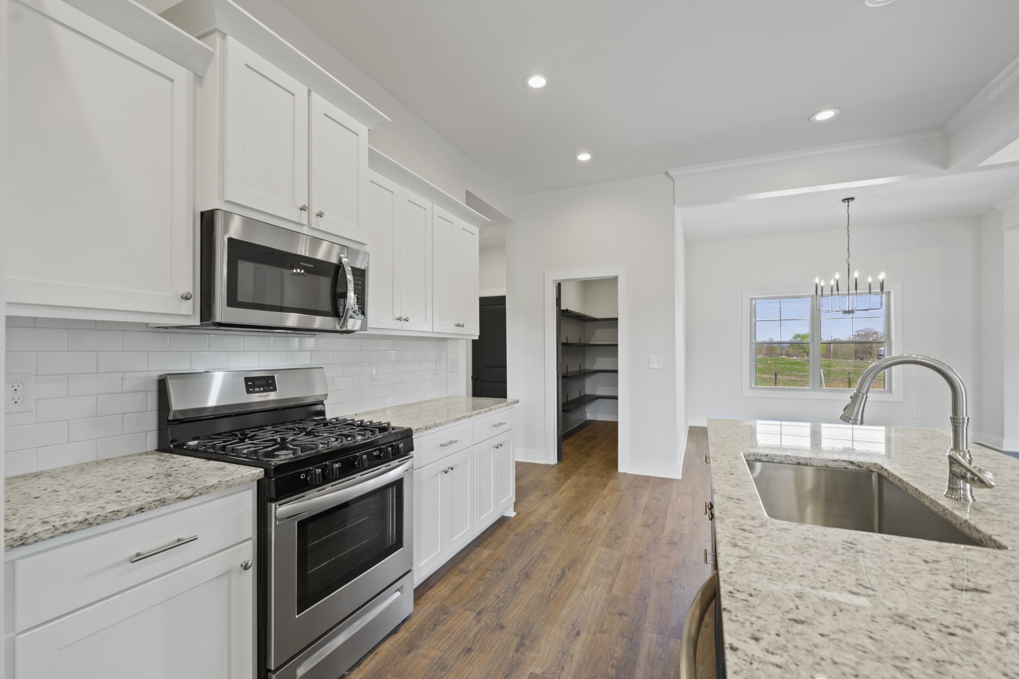 3368 Calista Road White House, TN 37188 - Photo 16 of 37 a kitchen with granite countertop a sink cabinets and stainless steel appliances