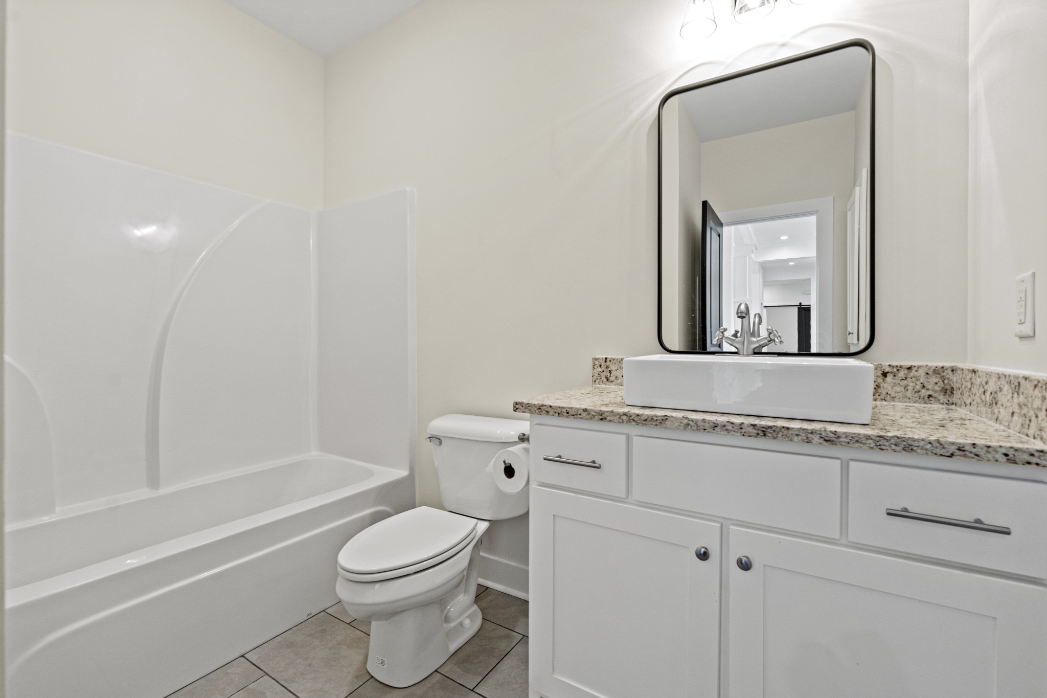 3368 Calista Road White House, TN 37188 - Photo 29 of 37 a bathroom with a granite countertop toilet a sink and a mirror