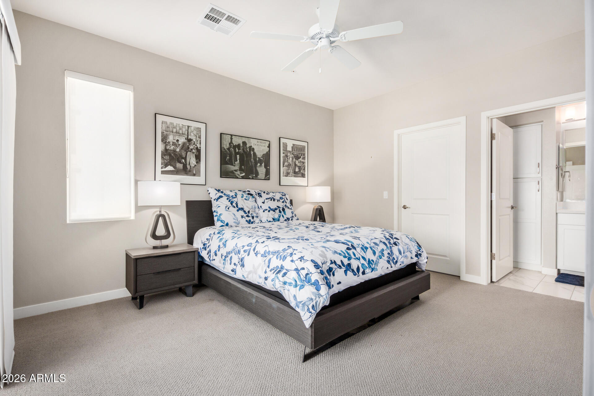 2511 West Queen Creek Road, Unit 258 Chandler, AZ 85248 - Photo 11 of 28 a bedroom with a bed and a chandelier