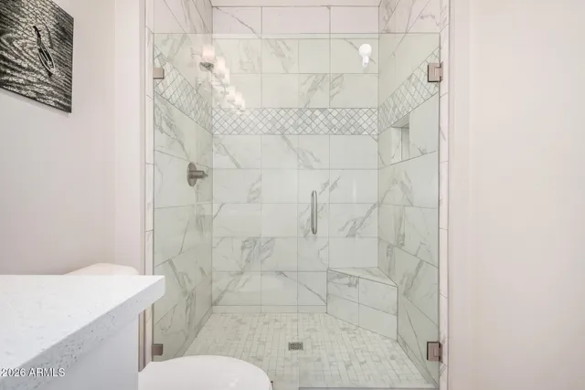 a bathroom with a shower toilet and sink