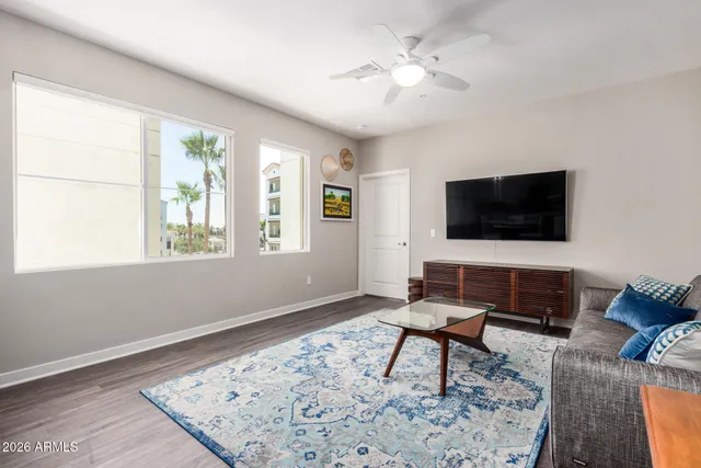 a living room with furniture and a flat screen tv