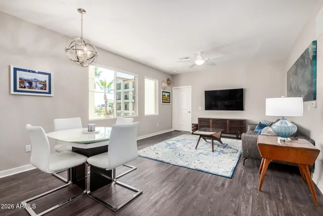 a living room with furniture a flat screen tv and a window