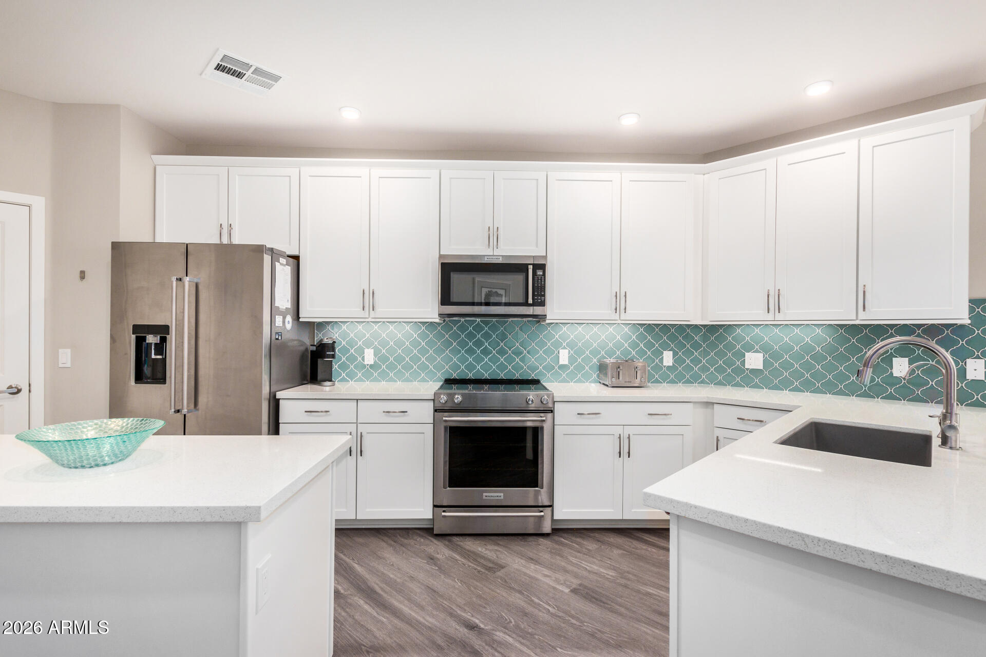 2511 West Queen Creek Road, Unit 258 Chandler, AZ 85248 - Photo 3 of 28 a kitchen with a sink a stove and refrigerator