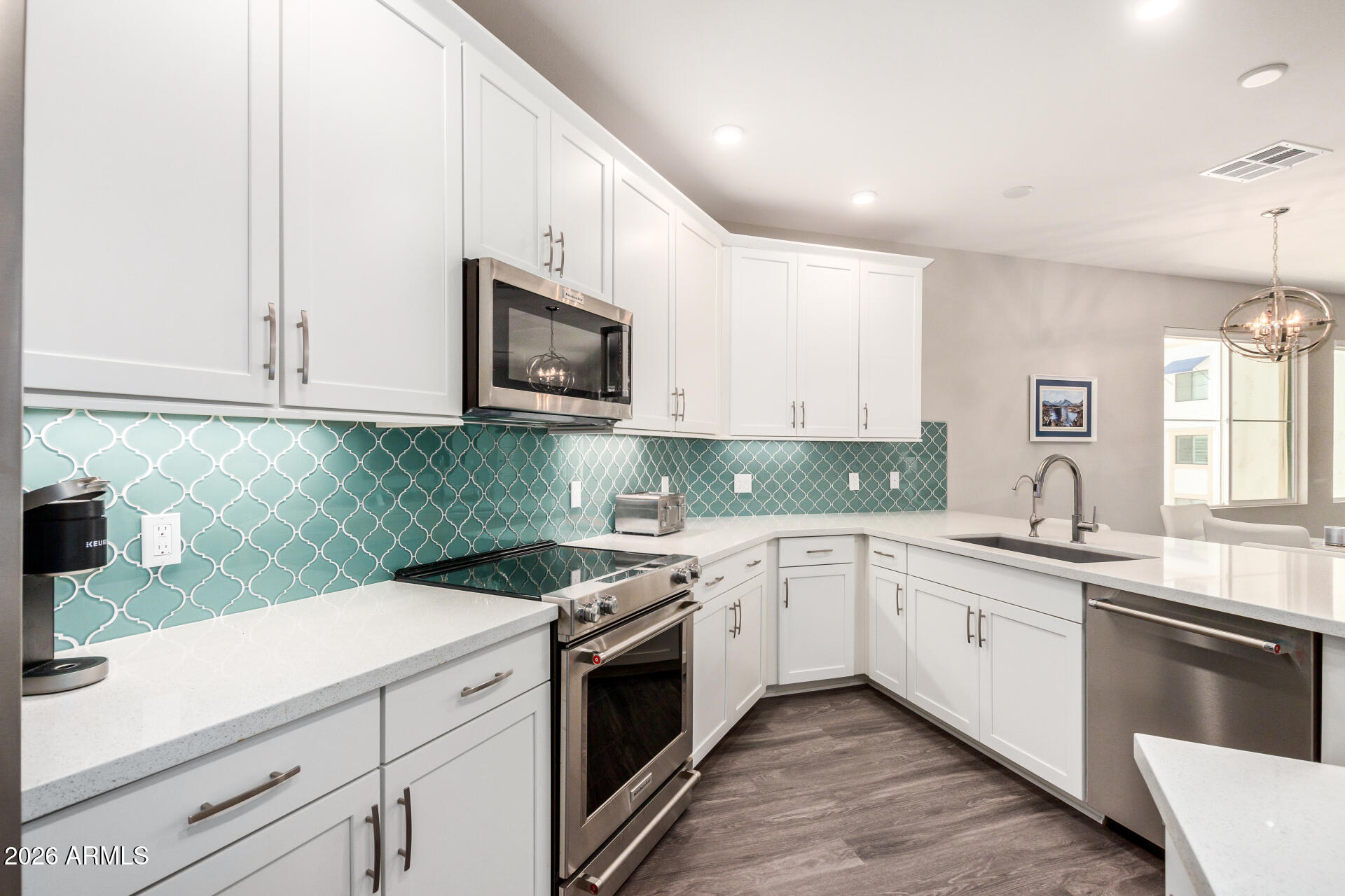 2511 West Queen Creek Road, Unit 258 Chandler, AZ 85248 - Photo 4 of 28 a kitchen with granite countertop white cabinets and white appliances