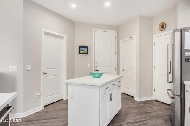 a kitchen with a stove top oven and a refrigerator