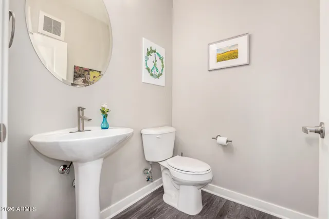 a bathroom with a sink mirror and toilet