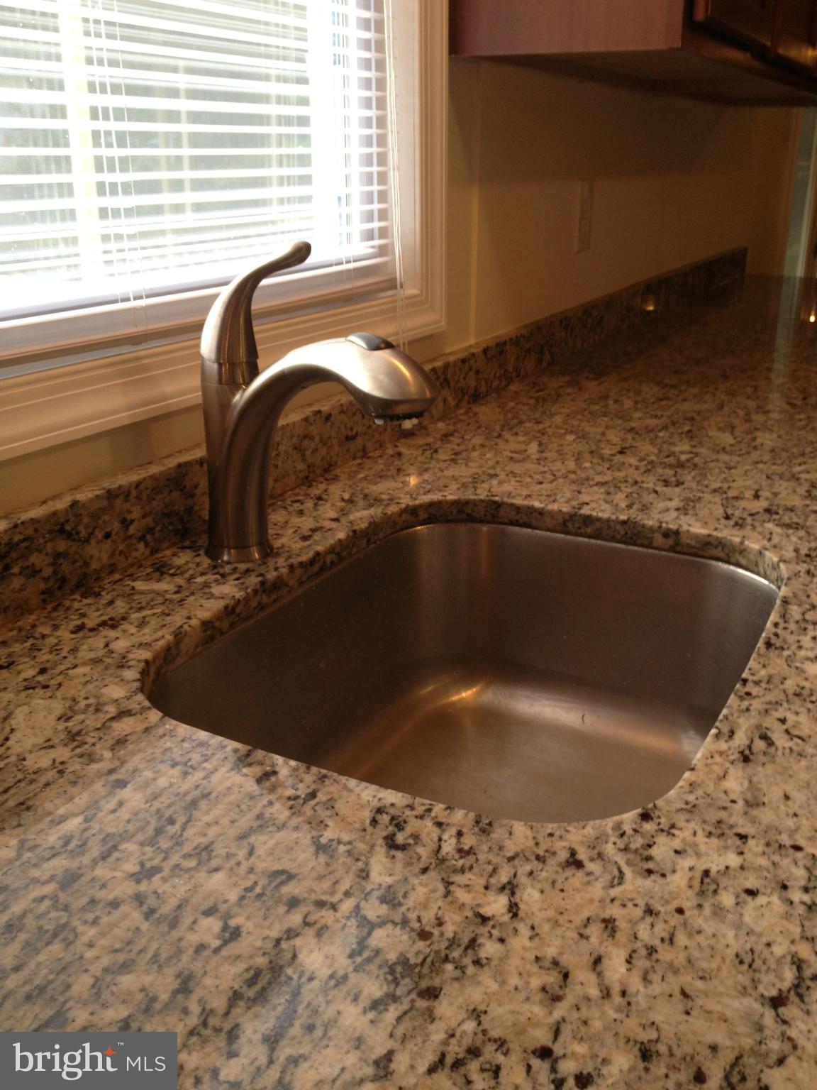 6432 St Phillips Road Linthicum, MD 21090 - Photo 11 of 27 a view of a sink a faucet a dining table and chair