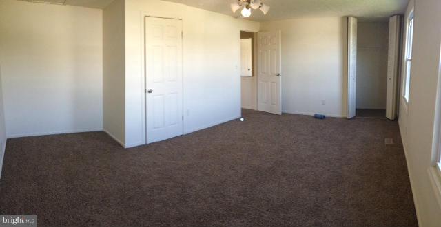 6432 St Phillips Road Linthicum, MD 21090 - Photo 21 of 27 an empty room that has a mirror in it