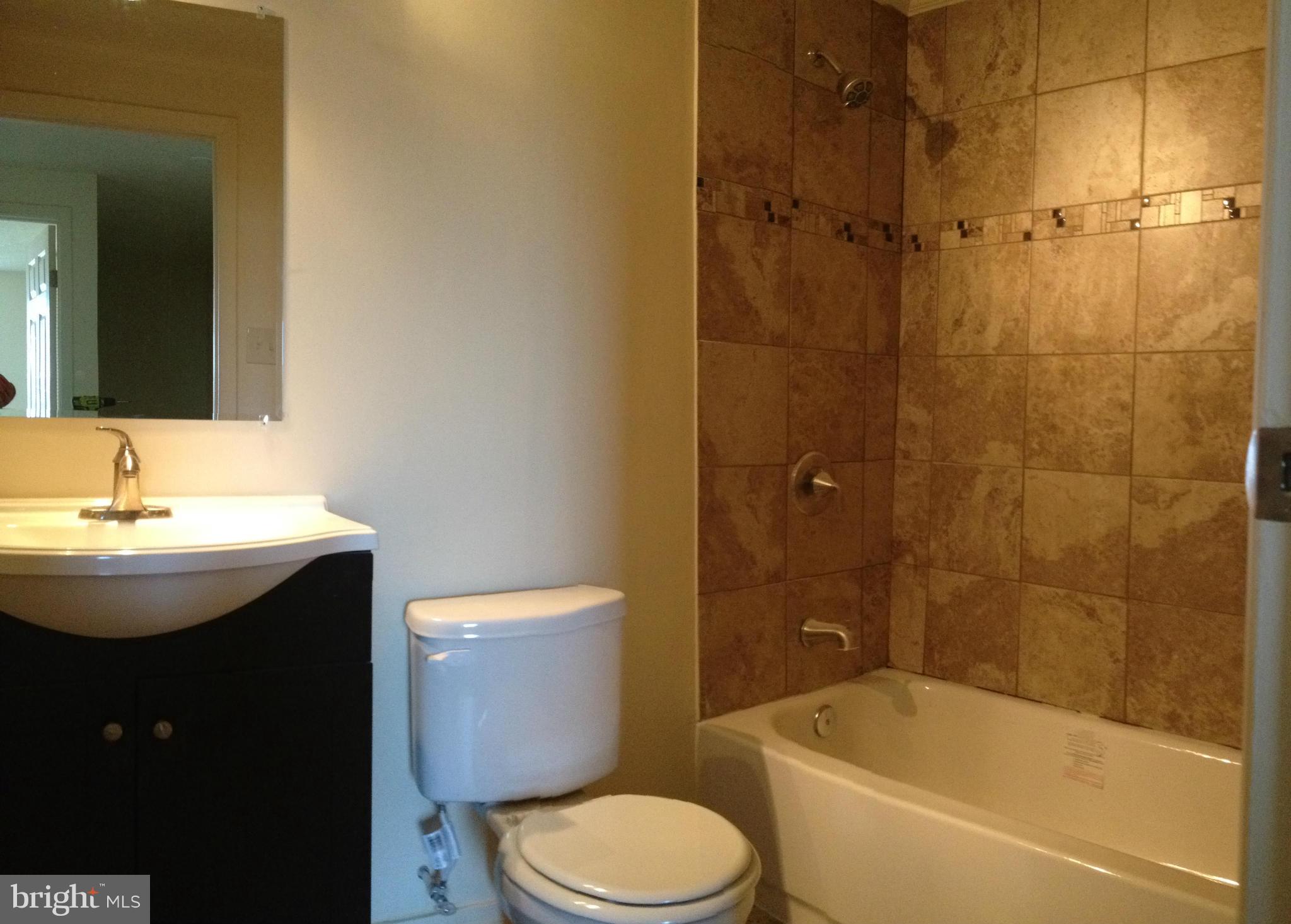 6432 St Phillips Road Linthicum, MD 21090 - Photo 23 of 27 a bathroom with a sink toilet and shower
