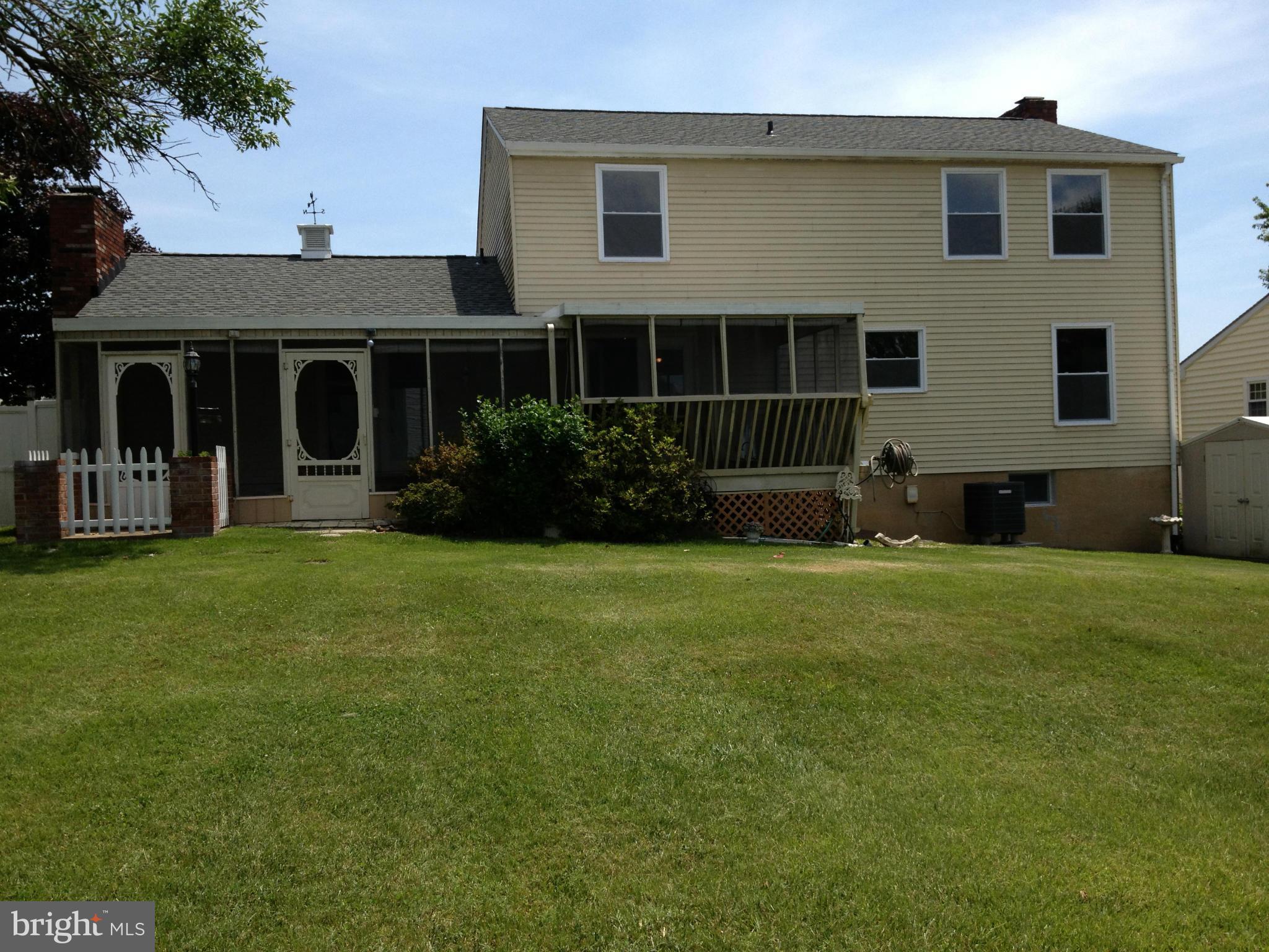 6432 St Phillips Road Linthicum, MD 21090 - Photo 5 of 27 a front view of a house with a yard and porch
