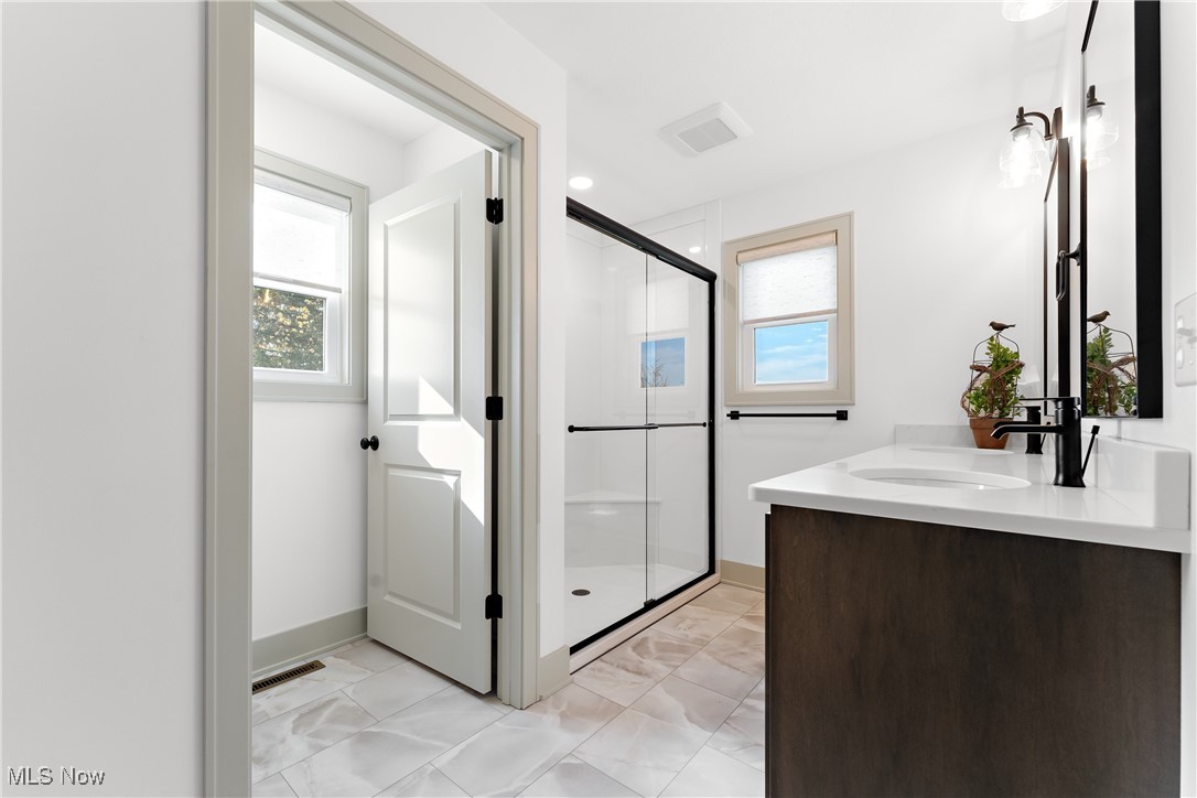 8664 Akron Road Marshallville, OH 44645 - Photo 15 of 29 Bathroom featuring a shower with shower door and vanity
