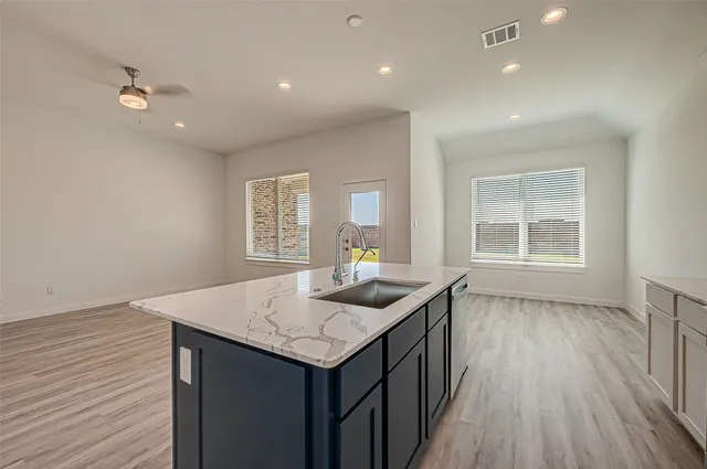 a kitchen with granite countertop kitchen island wooden floors and center island