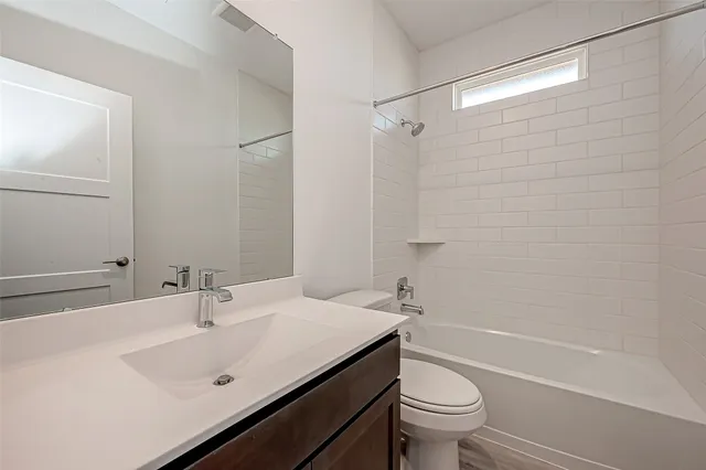 a bathroom with a sink toilet vanity and shower