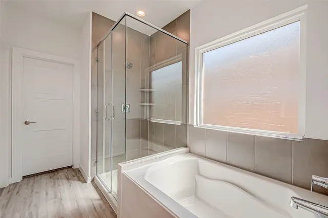 a bathroom with a bathtub and a shower