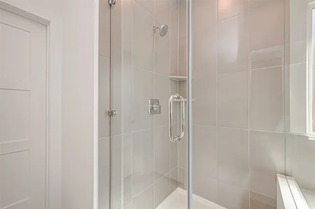 a bathroom with a glass shower door