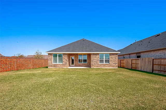 a view of a house with a yard and sitting area