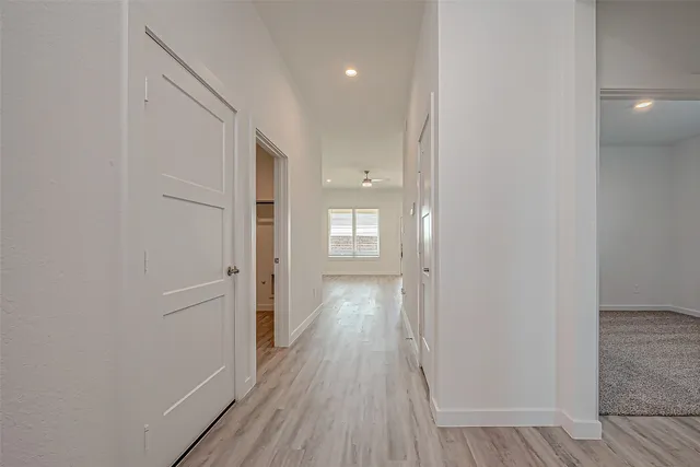 a view of hallway with wooden floor