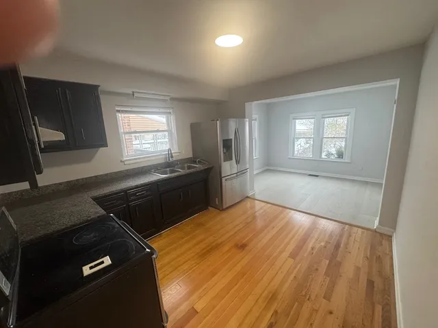 a kitchen that has a sink and a stove in it