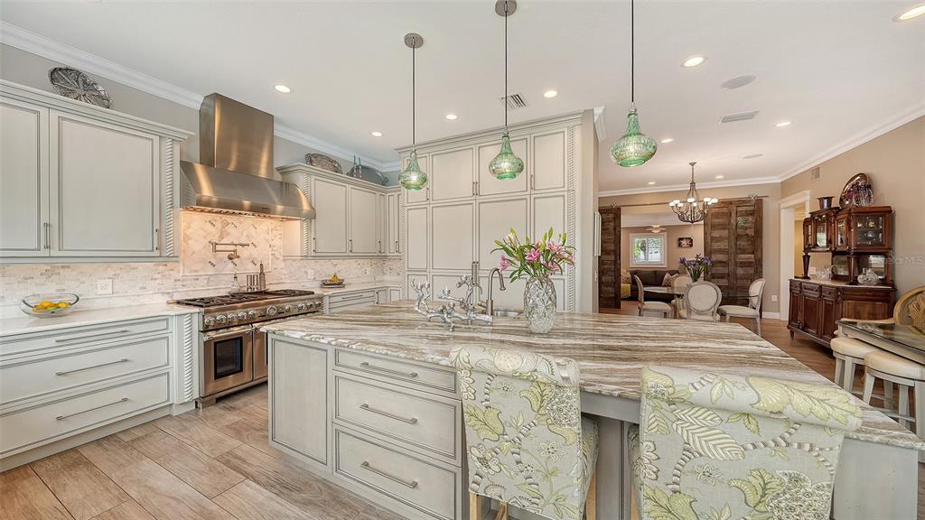 536 Ketch Lane Longboat Key, FL 34228 - Photo 25 of 80 a kitchen with a sink stainless steel appliances and wooden floor