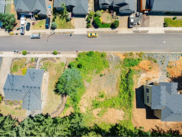 an aerial view of multiple houses with yard