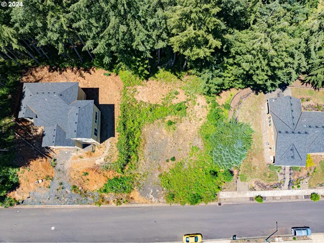 an aerial view of a houses with yard
