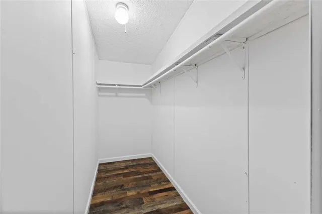 a view of a room with wooden floor and furniture