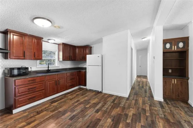 a kitchen with stainless steel appliances granite countertop a refrigerator and a stove