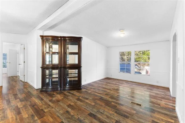 a view of a livingroom with furniture wooden floor and a chandelier