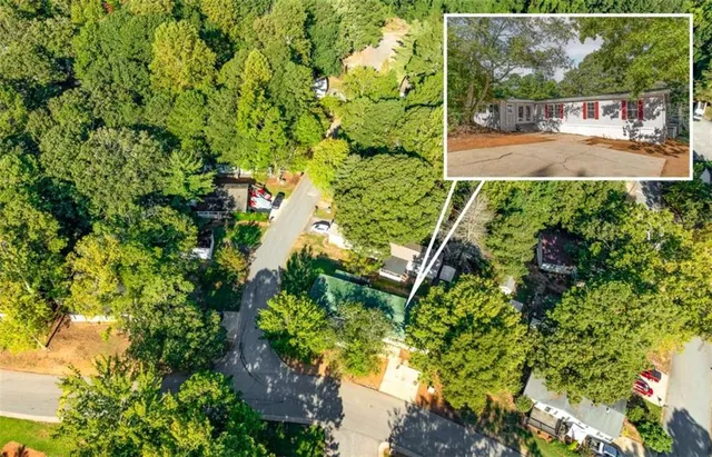 a view of a swimming pool with lawn chairs and plants
