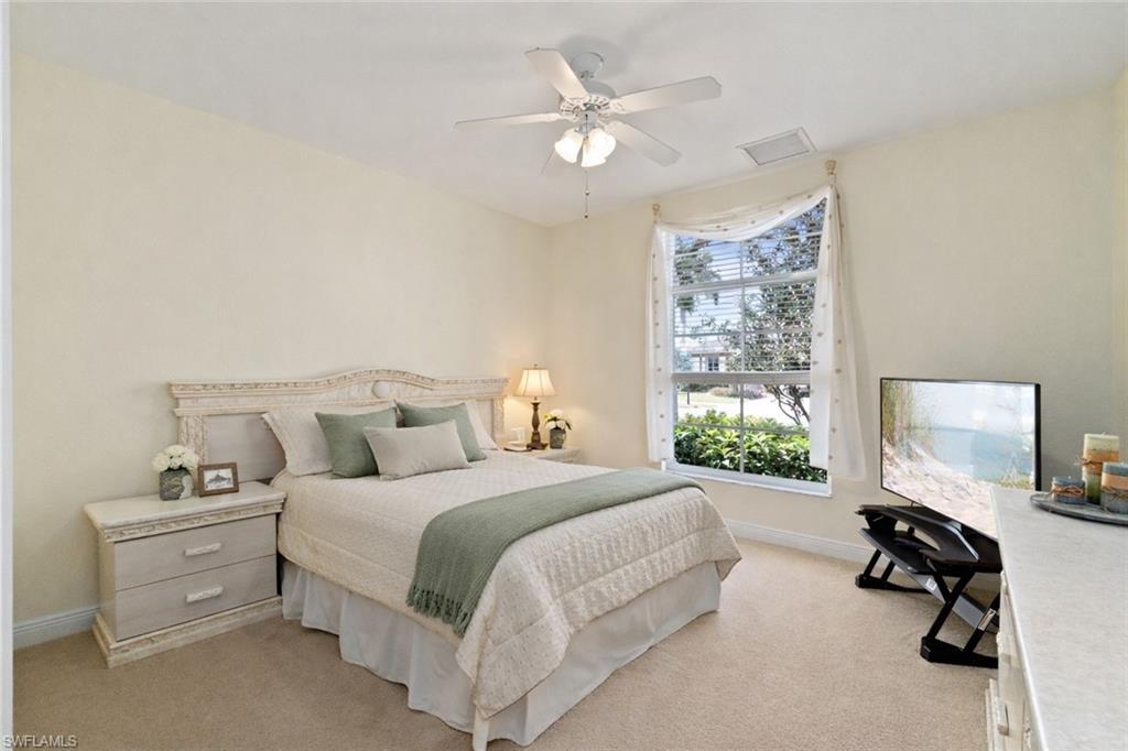 4832 Cerromar Drive Naples, FL 34112 - Photo 13 of 30 a bedroom with a bed a large window and furniture