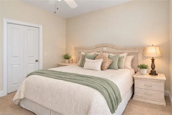 a bedroom with a bed and a lamp