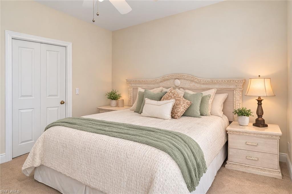 4832 Cerromar Drive Naples, FL 34112 - Photo 14 of 30 a bedroom with a bed and a lamp
