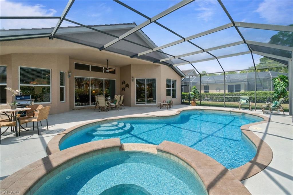 4832 Cerromar Drive Naples, FL 34112 - Photo 18 of 30 a swimming pool with outdoor seating and yard