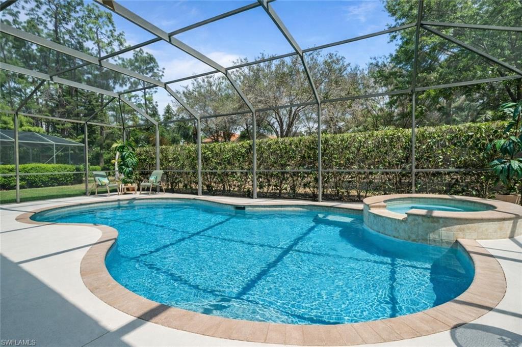 4832 Cerromar Drive Naples, FL 34112 - Photo 19 of 30 a view of a swimming pool with a patio