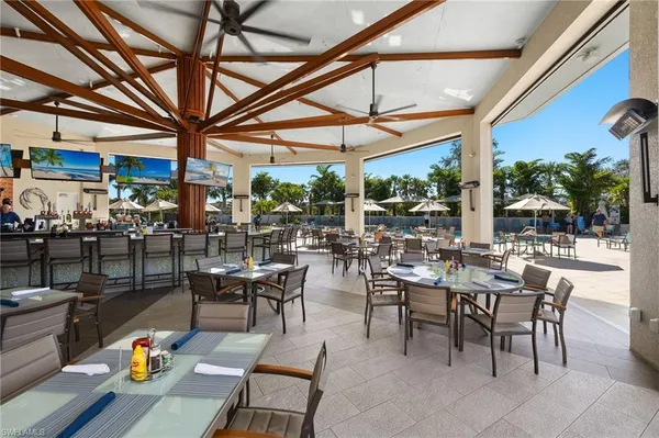 a view of a patio with dining table and chairs