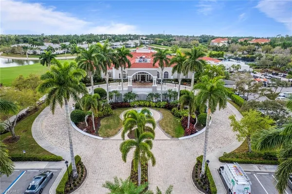 an aerial view of a house with a yard and lake view