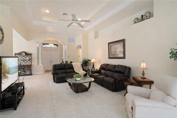 a living room with furniture and a lamp