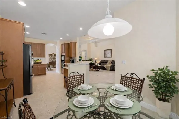 a kitchen with stainless steel appliances a dining table and chairs