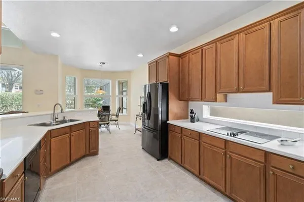 a kitchen with refrigerator and cabinets