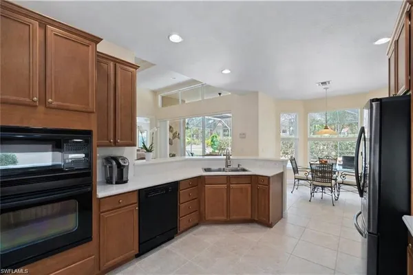 a large kitchen with a large counter top furniture and stainless steel appliances