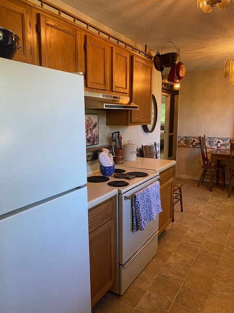 546 Rutledge Ford Road Decherd, TN 37324 - Photo 21 of 26 a kitchen with stainless steel appliances granite countertop a stove and a refrigerator